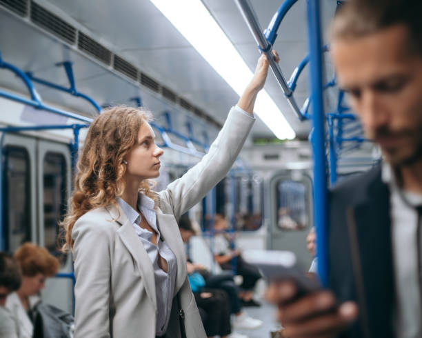 istock young business woman standing in a subway train 1287292833