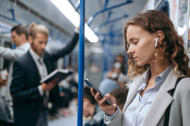 istock young woman reads a text message on a subway train 1287292857
