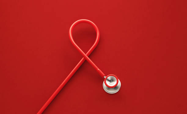 red stethoscope forming red aids awareness ribbon on red background - aids awareness ribbon imagens e fotografias de stock