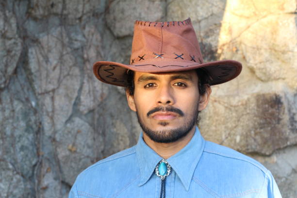 istock Cowboy wearing hat and denim shirt 1287294089