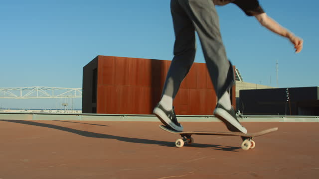 Cool modern millennial skater do skateboard trick