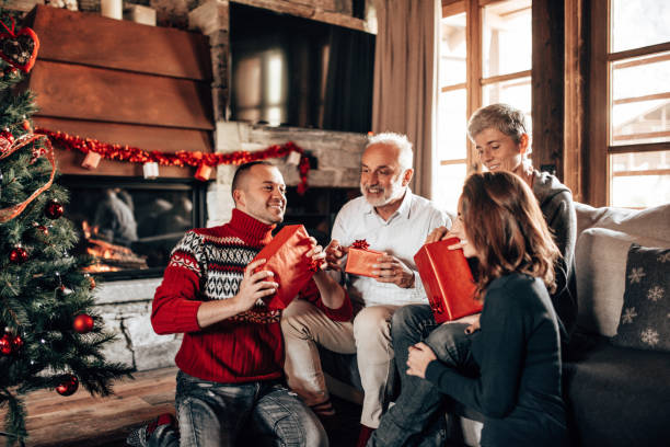 istock present exchaning at home for christmas 1287294621