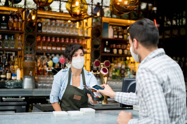 istock Man making a contactless payment at a restaurant during the pandemic 1287294897