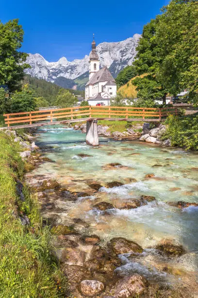 Sankt Sebastian pilgrimage church with alpine turquoise river alpine landscape view, Ramsau, Berchtesgadener Land National Park, Bavaria, Germany