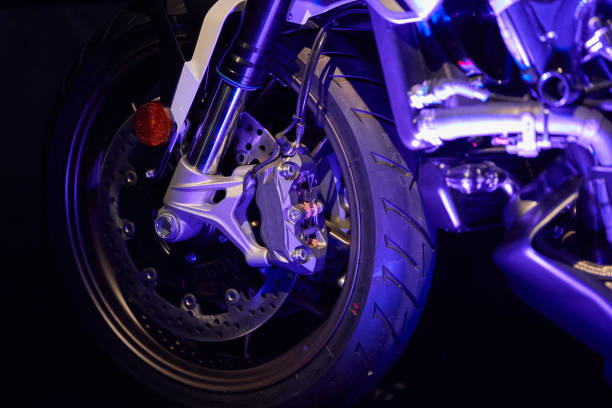 istock The front wheel of a modern motorcycle with blue lighting. Studio shooting. 1287296497