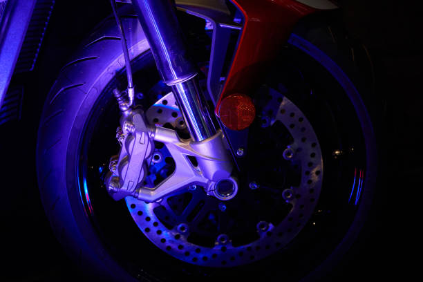 istock The front wheel of a modern motorcycle with blue lighting. Studio shooting. 1287296515