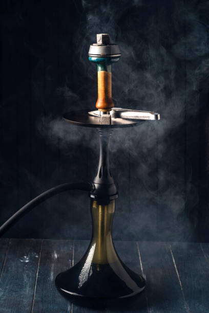 istock Hookah in smoke on dark wooden background 1287297534