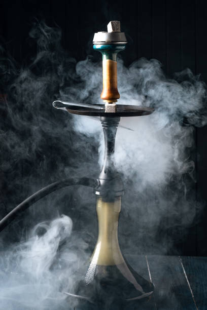 istock Hookah in smoke on dark wooden background 1287297559