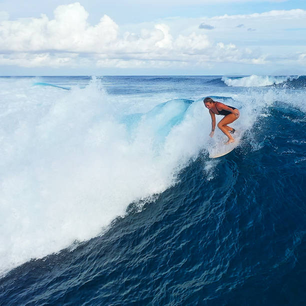 istock Surfer woman riding on the blue ocean 1287299134