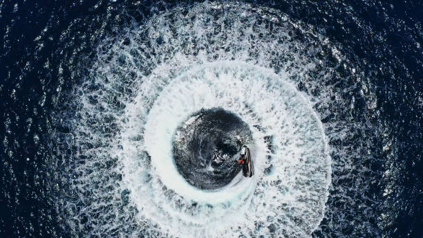 istock Drone view of man jet skiing in circles 1287299492