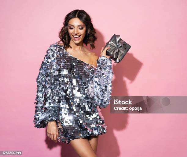 Beautiful Happy Woman Wearing Sparkle Dress With Gift Box At Celebration Party New Year Eve Celebrating Concept Stock Photo - Download Image Now