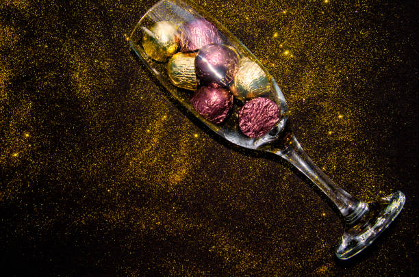 istock Champagne flute glass with candy truffles for special Event 1287304540