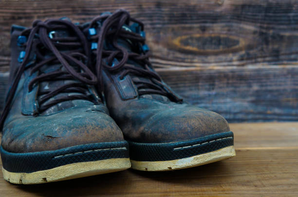 istock old brown leather shoes on a wooden background 1287304748