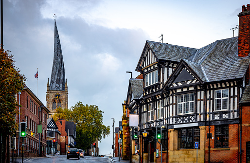 Street with historic residential buildings and the Benedictine Abbey in the background