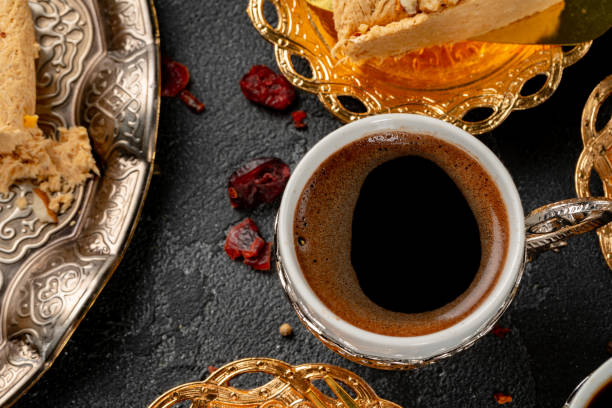 istock Cup of coffee and turkish pastries on dark surface 1287307374
