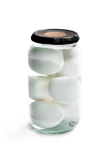 Pickled  eggs in the glass jar isolated on white