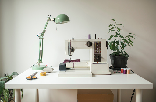 Retro styled tailor workshop with sewing machine.