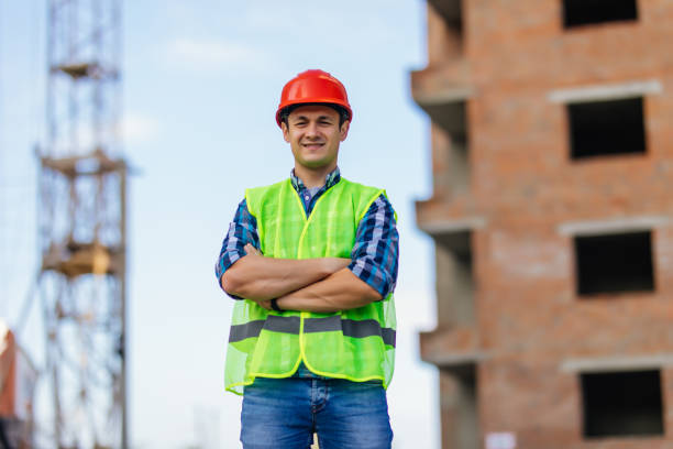istock Building, construction and people concept. Close up of builder crossed hands in front of constraction 1287310581