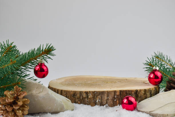 Minimum. Christmas background with a podium for presentation of the product. The pedestal is made of natural wood. Background with a wooden stand with a fir branch and balls for the Christmas tree. Happy New year and merry Christmas. evening ball photos stock pictures, royalty-free photos & images