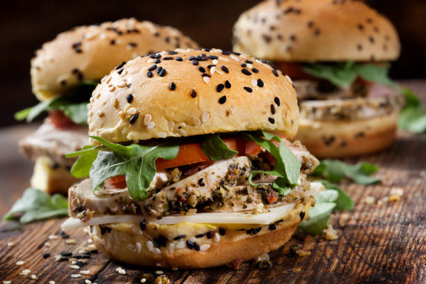 Roast Pork Sliders with Swiss Cheese, Tomato and Arugula on Brioche Sesame Seed Buns