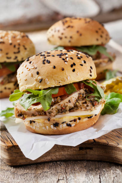 Roast Pork Sliders with Swiss Cheese, Tomato and Arugula on Brioche Sesame Seed Buns