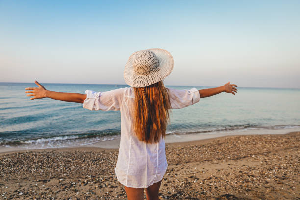 istock Happy woman on the beach 1287311649