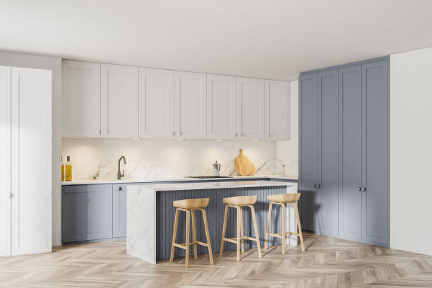 istock Stylish white and gray kitchen corner with bar 1287311748