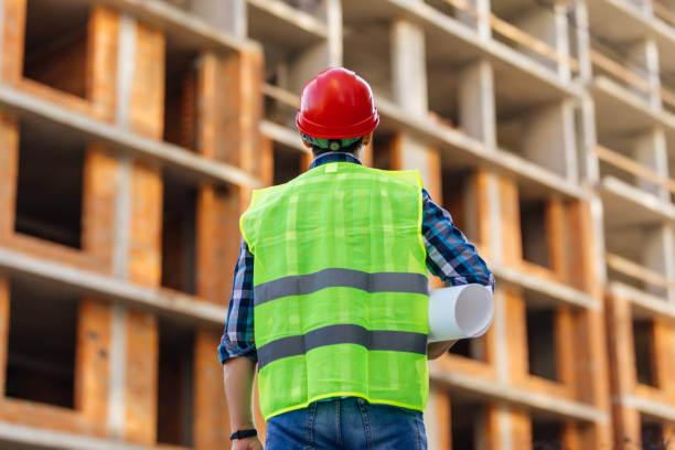 istock Rear view of architect looking comparing housing project with building 1287311777