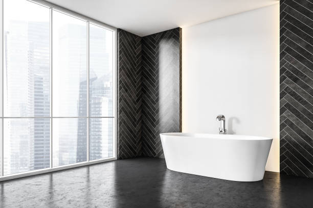 istock Modern white bath in a big bathroom with backlight, tile black wall on the side 1287311802