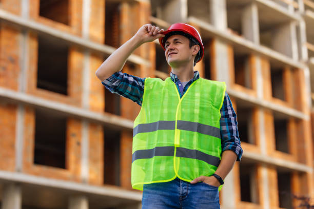 istock Civil engineer in helmet and working checklist construction with building construction background 1287311856