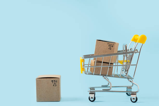 istock Toy shopping cart with boxes on blue background 1287312806