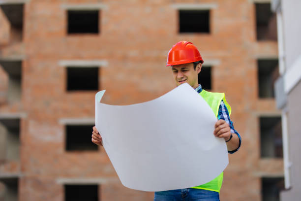 istock Young startup business architect man working on construction with blueprint outdoors 1287312930