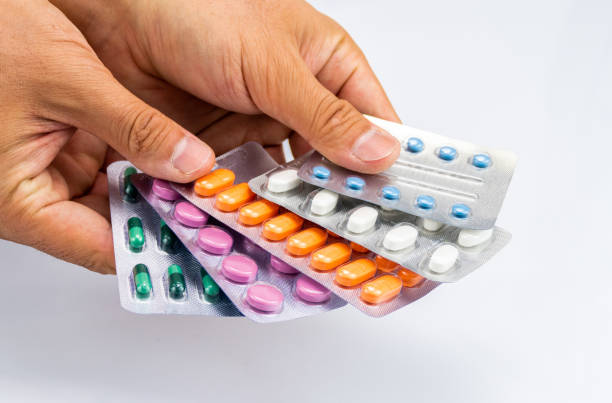 istock Man Shows Various Pills Holding In His Hand Like Playing Cards 1287313895