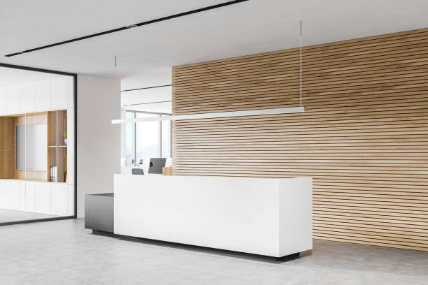 istock Modern white and wooden office waiting room corner with reception 1287314069