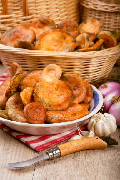 istock Saffron milk caps in baskets and bowls on the kitchen table 1287315932
