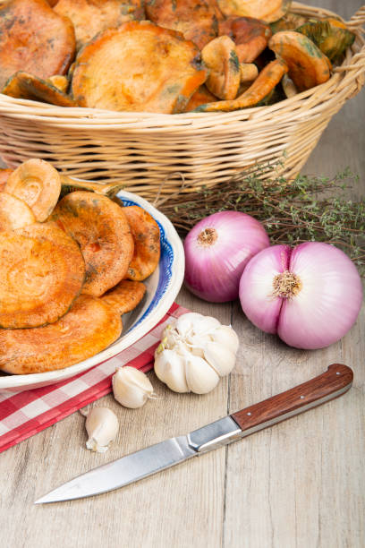 istock Saffron milk caps in baskets and bowls on the kitchen table 1287315985