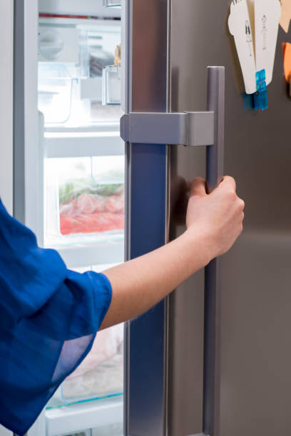 istock Woman hand opening a refrigerator door 1287316975