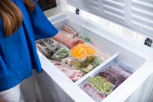 istock A woman putting orange slices into fridge 1287317510