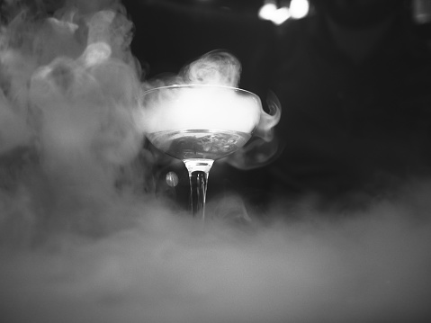 Martini glass chilled with dry ice before served,in a mystic smoke