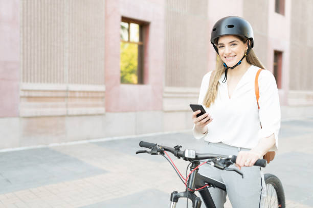 istock Businesswoman using her smartphone before starting her bike commute 1287317829