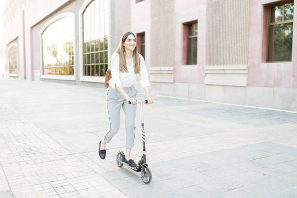 istock Professional woman looking happy using a scooter 1287318472
