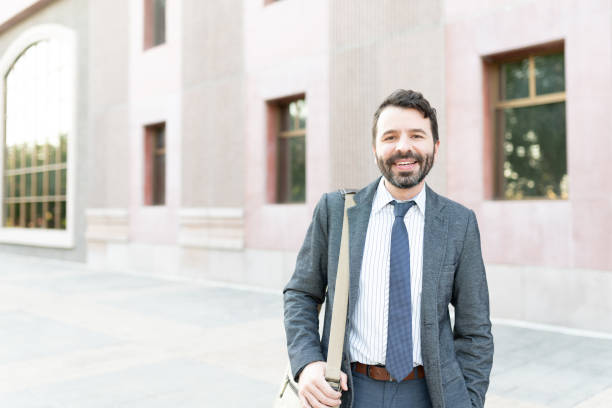 istock Businessman smiling outside an office building 1287318548