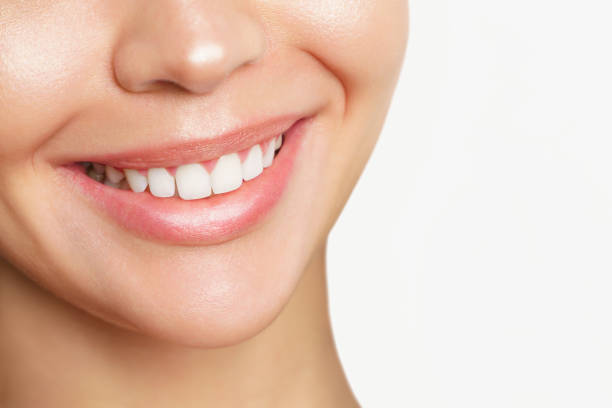 istock Beautiful young woman with healthy teeth on white background 1287320205