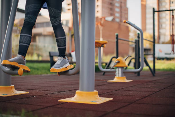 One young beautiful sportswoman exercising in outdoor gym.