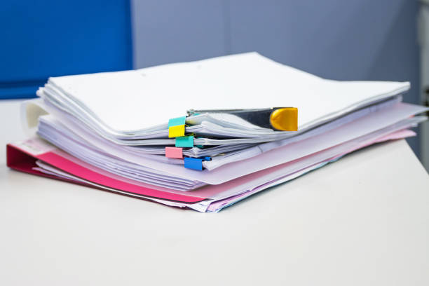 istock file folder and Stack of business report paper file on the table in a work office, concept document in work office 1287322657