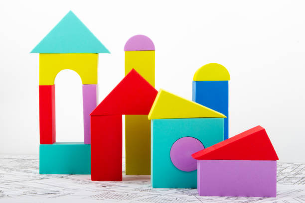 istock Houses made of colored blocks on a light background. Design and construction concept. 1287323526
