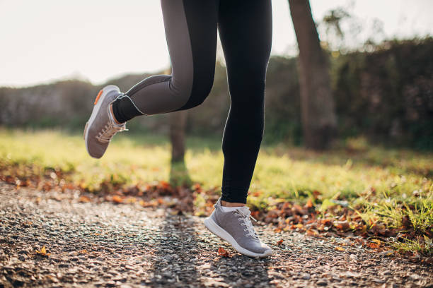 istock Sportswoman jogging outdoors 1287323723