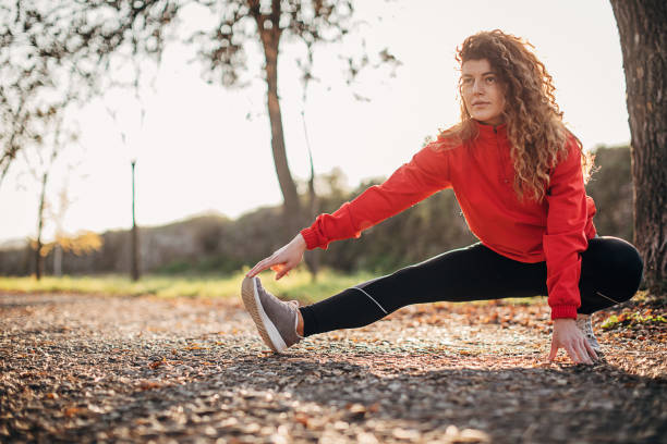 istock Beautiful young sportswoman stretching before jogging 1287324662