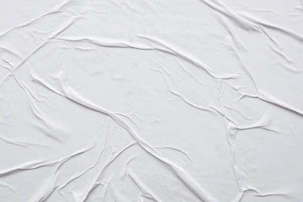 istock Blank white crumpled and creased paper poster texture background 1287326928