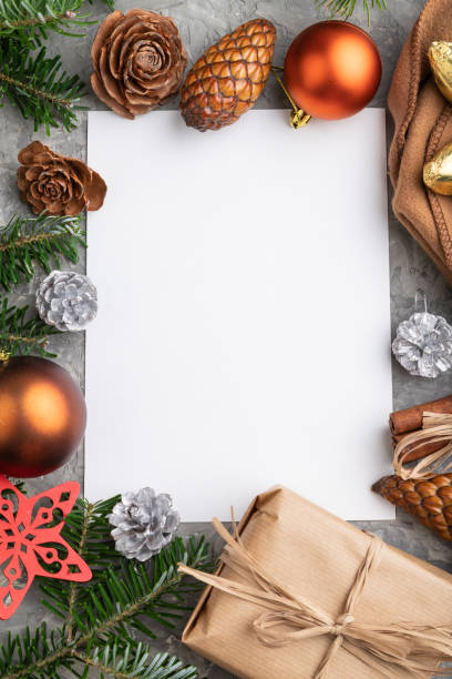 istock Christmas or New Year frame composition, template. Decorations, cones, cinnamon, fir and spruce branches, cup of coffee, wool scarf on a gray concrete background. Top view, copy space, flat lay. 1287328011